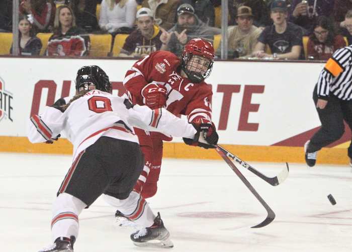 Wisconsin's Britta Curl (17) gets a shot past Ohio State's Madison Bizal during the first period of the NCAA Division I women's hockey championship game on Sunday March 19, 2023 at AMSOIL Arena in Duluth, Minn. Uwice Ohio State 2 March 19 2023